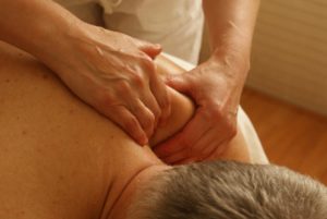 man getting shoulder massage physiotherapy